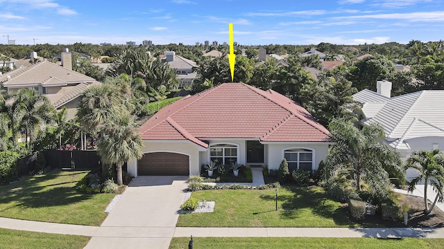 view of front of home featuring a front yard and a garage