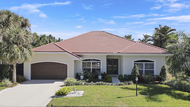 mediterranean / spanish-style home with a garage and a front lawn