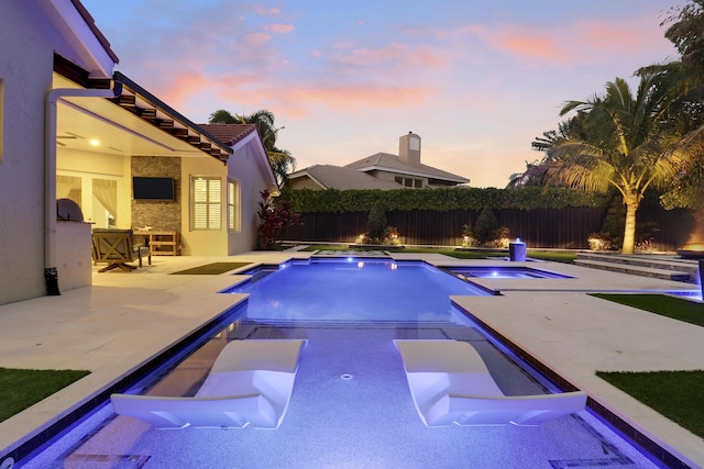 view of pool with an in ground hot tub and a patio