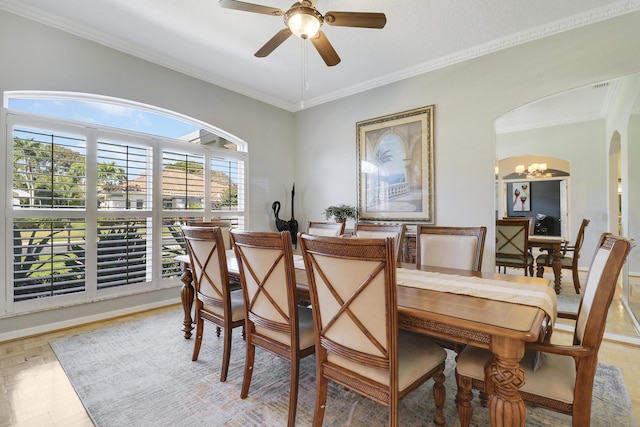 dining space featuring ornamental molding, ceiling fan with notable chandelier, and parquet flooring