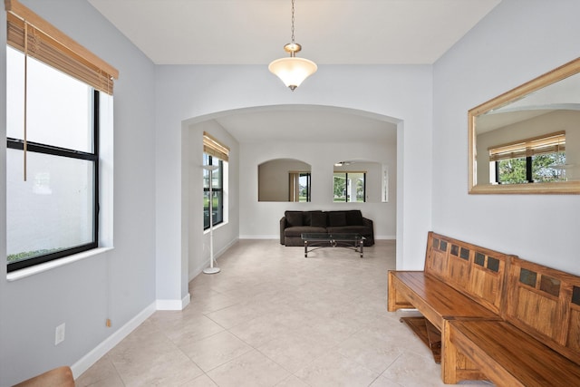 corridor featuring plenty of natural light and light tile patterned floors