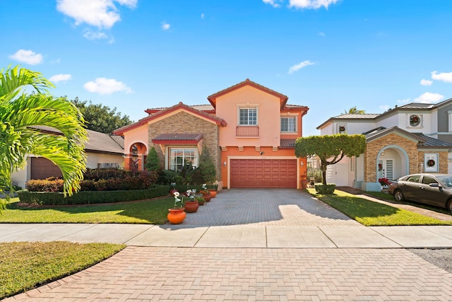 mediterranean / spanish-style house with a front yard and a garage