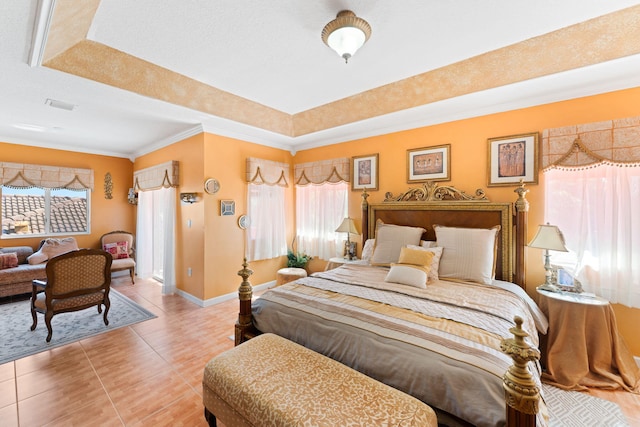 bedroom featuring tile patterned floors, a raised ceiling, and crown molding