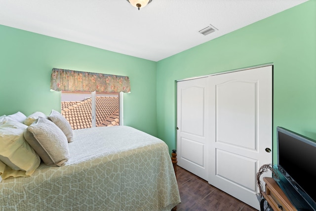 bedroom with a closet and dark hardwood / wood-style floors