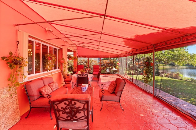 view of patio with outdoor lounge area and a water view