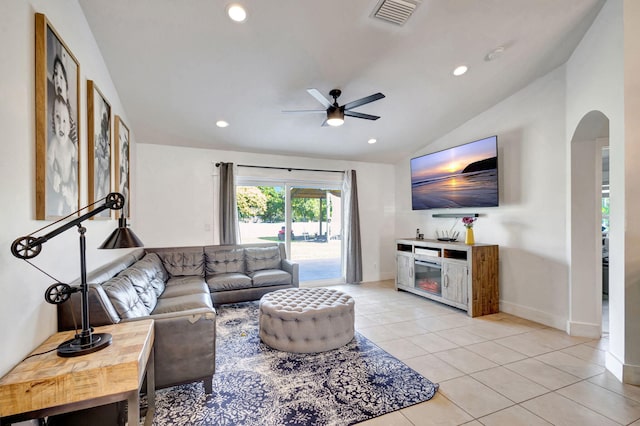 living room with ceiling fan, light tile patterned flooring, and vaulted ceiling