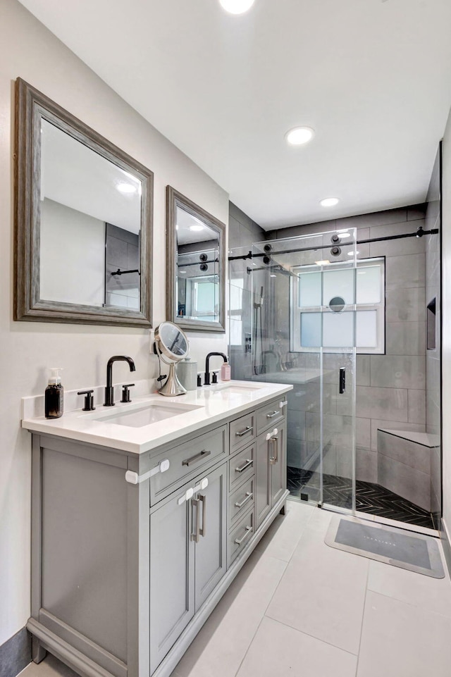 bathroom featuring tile patterned flooring, vanity, and walk in shower