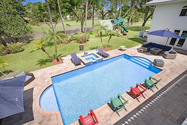 view of swimming pool featuring outdoor lounge area, a yard, an in ground hot tub, and a patio area