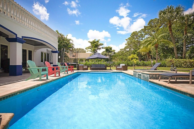 view of swimming pool featuring outdoor lounge area, an in ground hot tub, and a patio