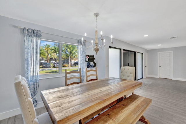 dining room featuring a chandelier and light hardwood / wood-style flooring