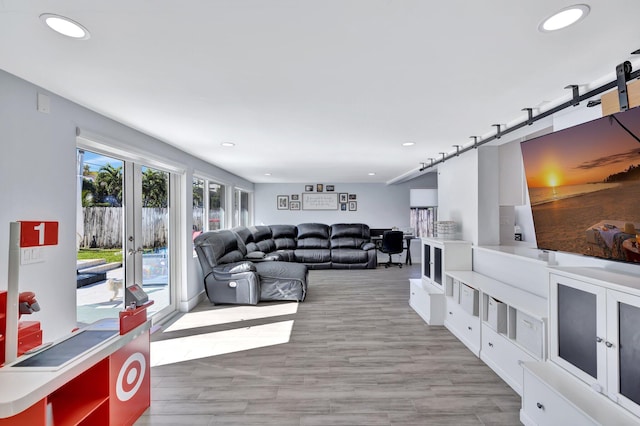 living room with light hardwood / wood-style floors and french doors