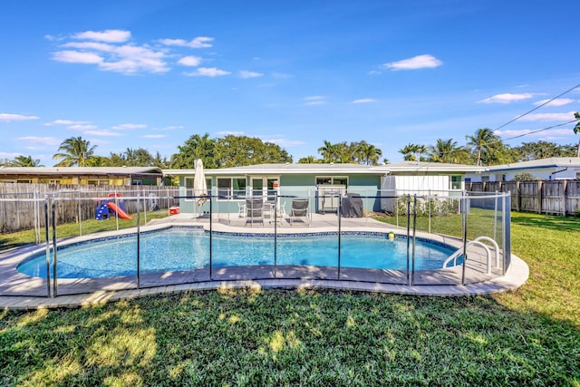 view of swimming pool featuring a lawn and a patio