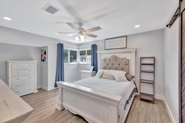 bedroom with ceiling fan and light hardwood / wood-style flooring