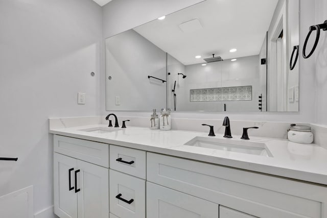 bathroom with vanity and a shower