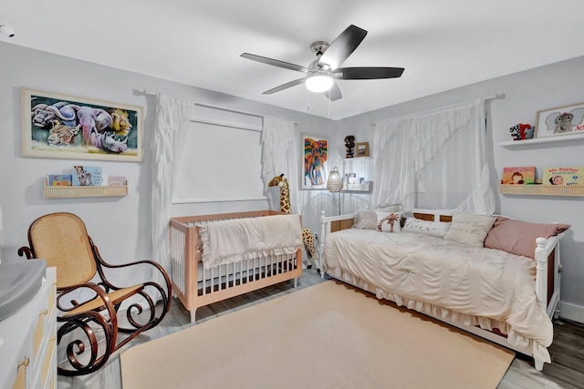 bedroom featuring hardwood / wood-style flooring and ceiling fan