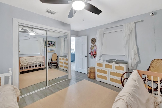 bedroom with hardwood / wood-style flooring, a closet, and ceiling fan