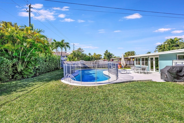 view of swimming pool featuring a yard and a patio