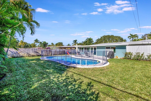 view of pool featuring a patio area and a yard