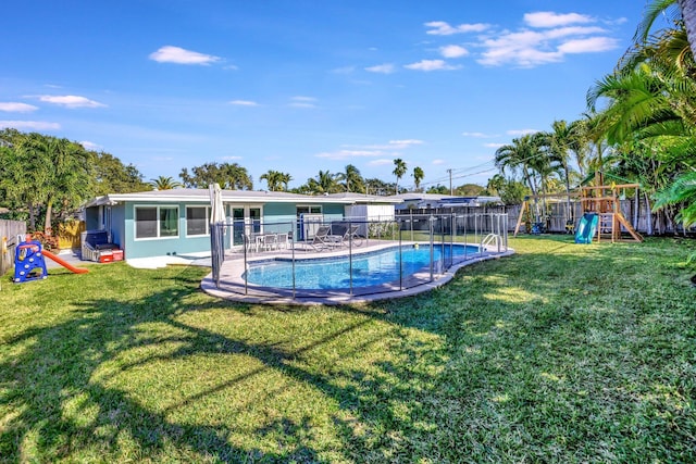 view of pool with a playground and a yard