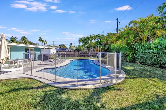 view of swimming pool with a patio area and a yard