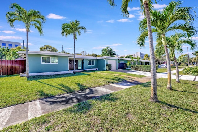 single story home featuring a front lawn and a garage