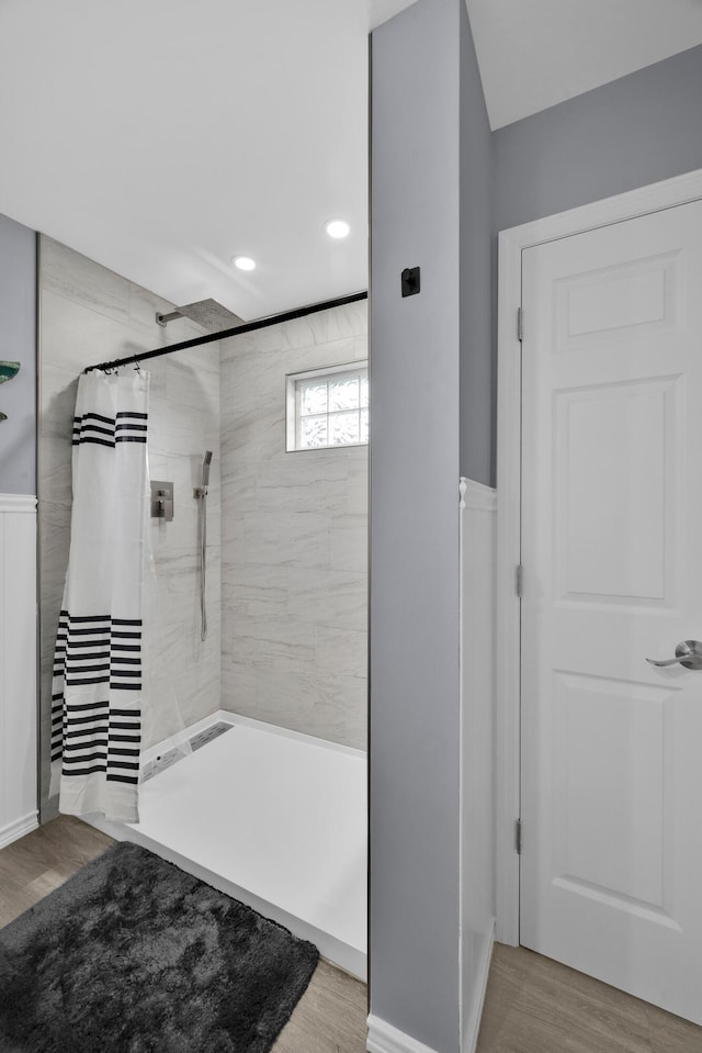 bathroom featuring curtained shower and hardwood / wood-style floors