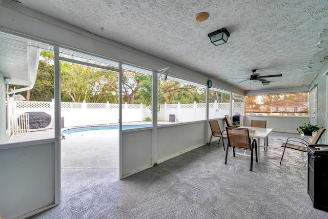 sunroom featuring ceiling fan