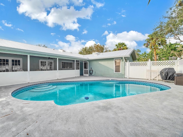 view of pool with a patio and grilling area