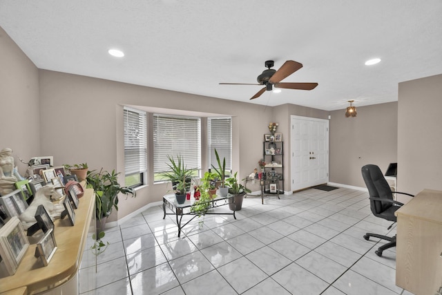 tiled home office featuring ceiling fan