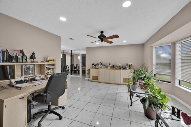 office space featuring light tile patterned floors, a textured ceiling, and ceiling fan