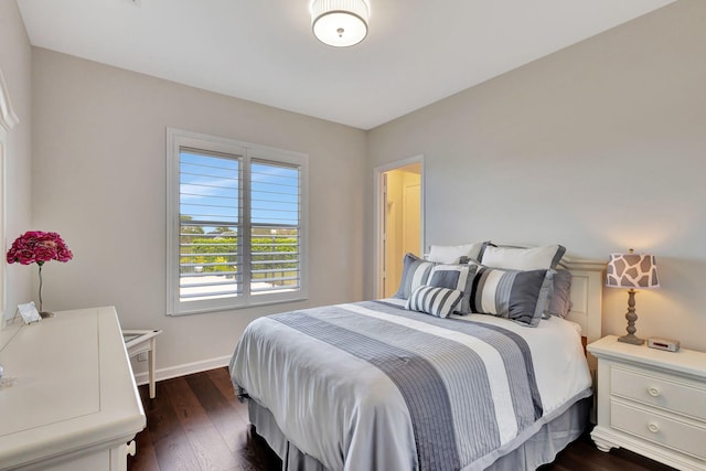 bedroom with dark hardwood / wood-style floors