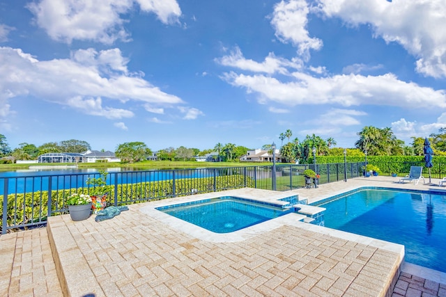 view of swimming pool with an in ground hot tub, a patio, and a water view