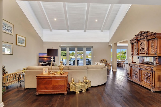 living room featuring dark hardwood / wood-style flooring and vaulted ceiling with beams