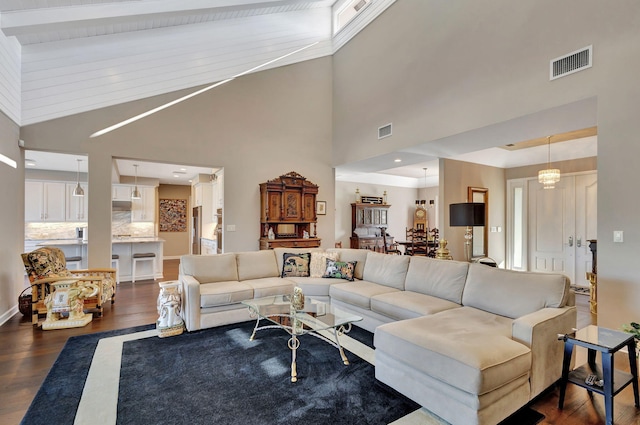 living room featuring dark wood-type flooring and vaulted ceiling