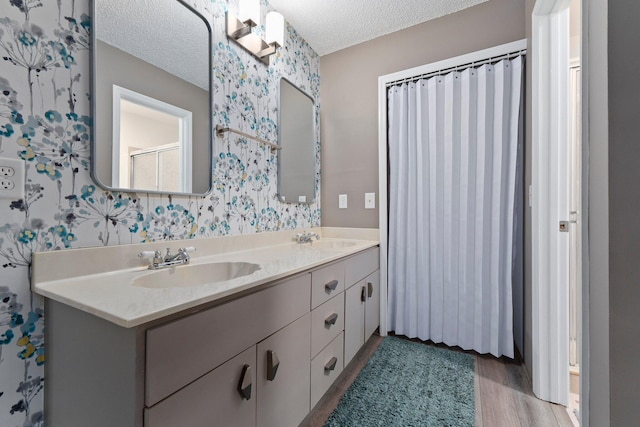 bathroom with vanity, a textured ceiling, and hardwood / wood-style flooring