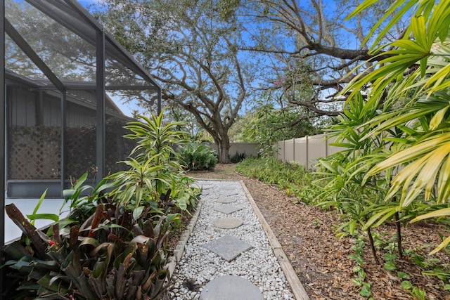 view of yard with glass enclosure