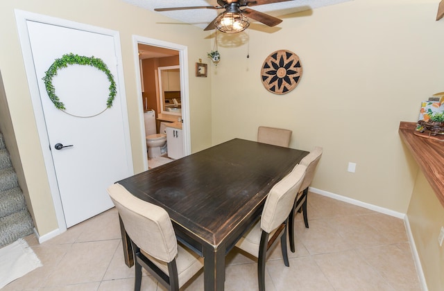 tiled dining area with ceiling fan