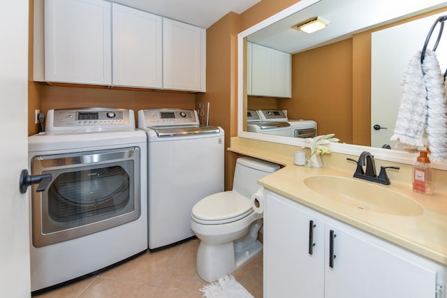 clothes washing area featuring washer and dryer, light tile patterned floors, and sink