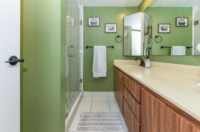 bathroom featuring tile patterned floors, vanity, and a shower with shower door