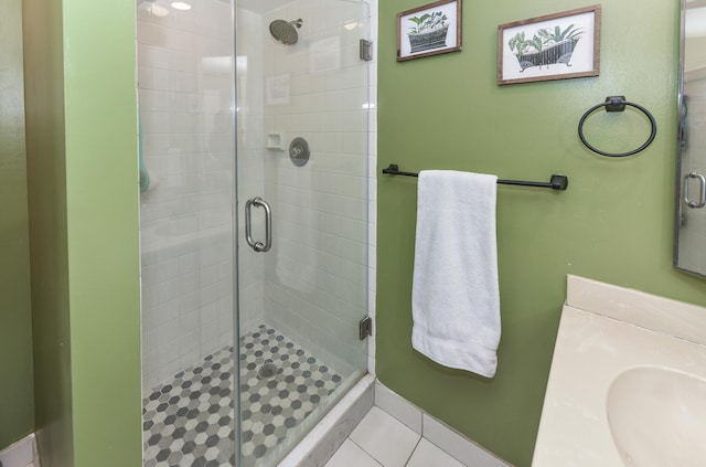 bathroom featuring vanity, tile patterned floors, and a shower with door