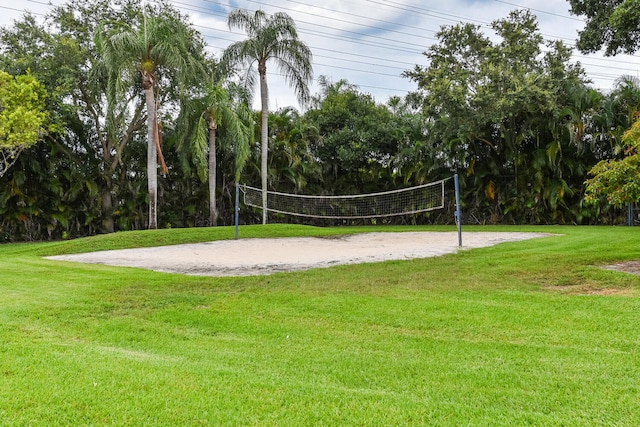 view of property's community with a yard and volleyball court