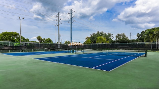 view of tennis court featuring basketball court