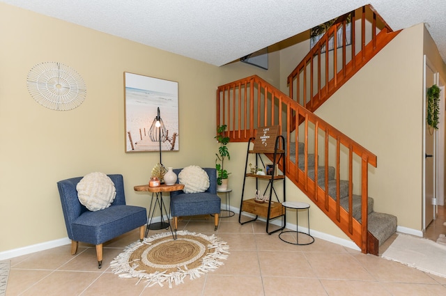 sitting room featuring tile patterned floors and a textured ceiling