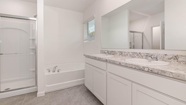 bathroom with tile patterned flooring, vanity, and shower with separate bathtub