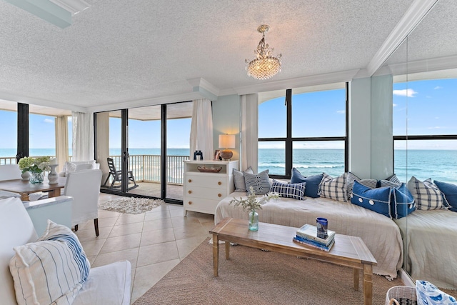 living room featuring expansive windows, light tile patterned flooring, a textured ceiling, a water view, and ornamental molding