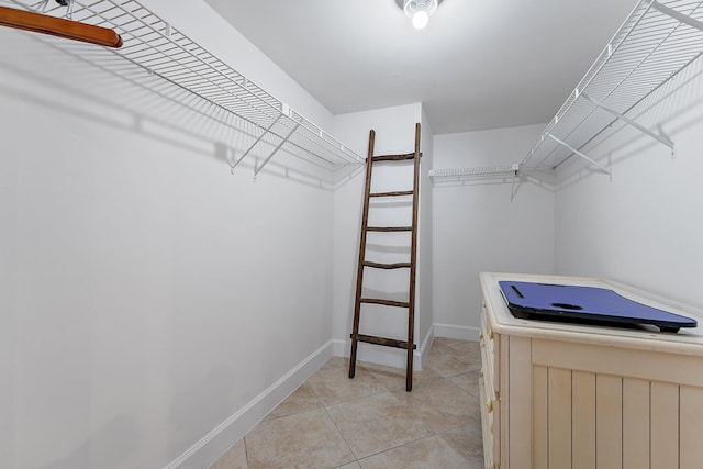 spacious closet featuring light tile patterned flooring