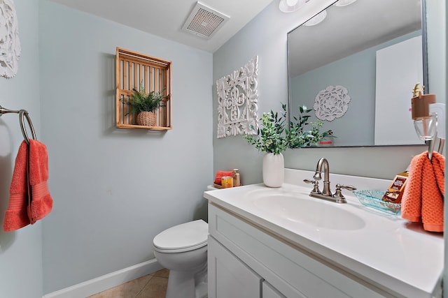 bathroom featuring tile patterned flooring, vanity, and toilet