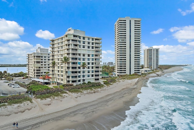 view of building exterior featuring a view of the beach and a water view