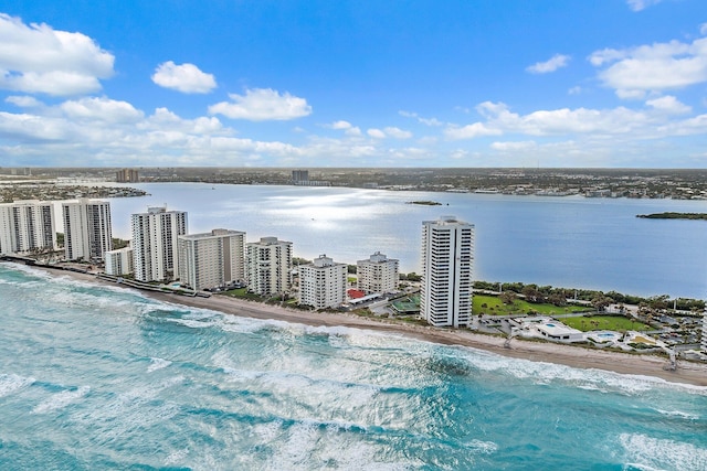 birds eye view of property featuring a water view and a beach view