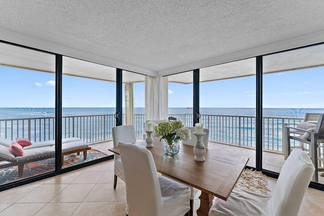 sunroom / solarium featuring a water view and plenty of natural light